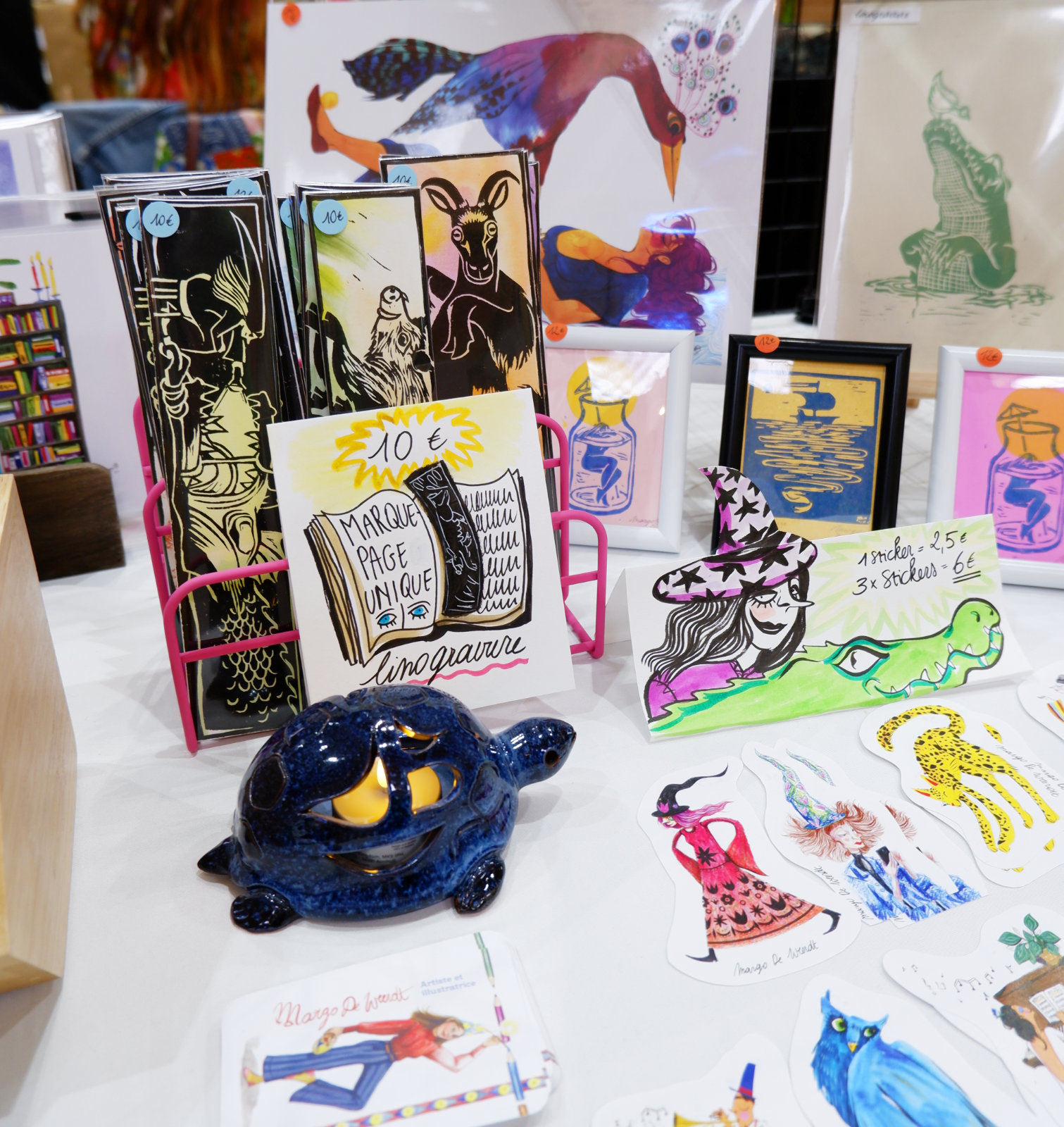 Photo in a market with stickers, prints and bookmarks made by Margo De Weerdt, artist and illustrator, living in Strasbourg, France